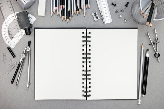 various drawing tools  with notebook on recycled paper backgroun