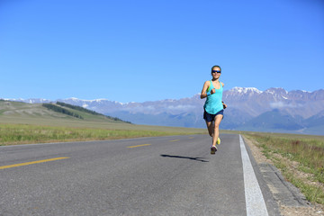 Fototapeta premium healthy lifestyle young fitness woman runner running on road