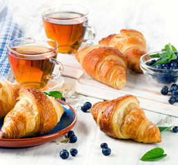 Fresh Croissants with Cups of Tea for a Breakfast.