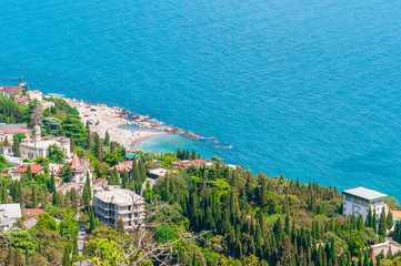 beach at the seaside, blue water, view from above  the mountains to the town of Simeiz, Yalta, Crimea