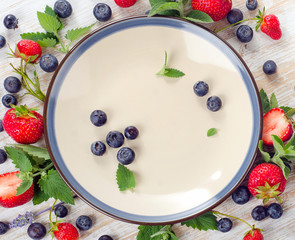 Various fresh berries and  plate for healthy eating.
