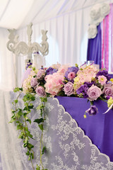 Beautiful wedding restaurant for marriage. White decor for bride and groom. Colorful decoration for celebration. Beauty bridal interior. Bouquet, food and flowers in hall