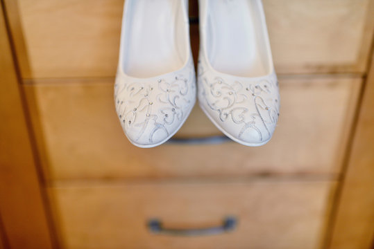 Beautiful colorful wedding shoes for bride indoors. Beauty of bridal heel for marriage. Female couple boots for celebration