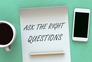 ASK THE RIGHT QUESTIONS, message on paper, smart phone and coffee on table, 3D rendering