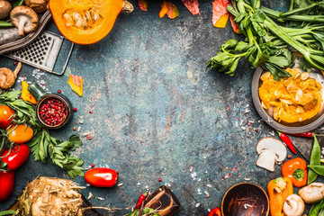 Autumn vegetables cooking preparation . Pumpkin, tomatoes, root vegetables and mushrooms ingredients on dark rustic background for  Thanksgiving Day recipes or menu card, top view, frame - obrazy, fototapety, plakaty