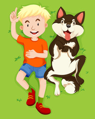 Boy and pet dog on grass