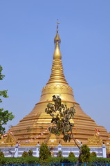 Naklejka premium Huge golden buddhist stipa in Kushinagar, India. It is important Buddhist pilgrimage site, where Buddhists believe Gautama Buddha attained Parinirvana after his death 