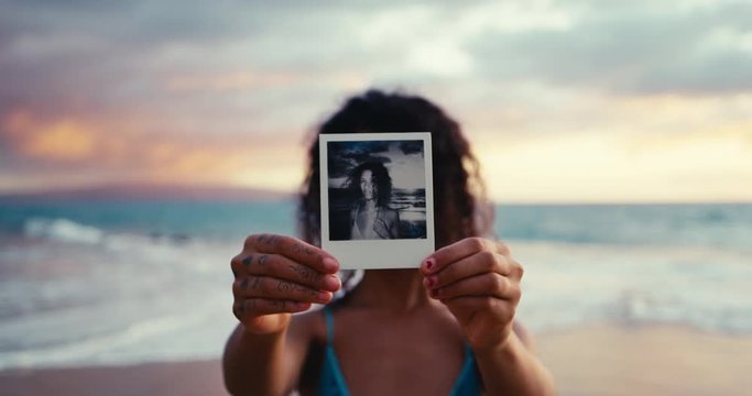 Polaroid portrait of beautiful young woman on the beach at sunset