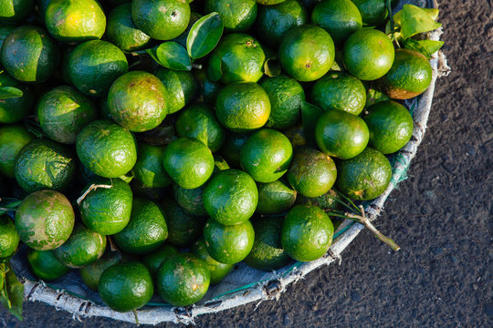 Basket with fresh limes at the street market, Vietnam