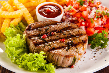 Grilled steak, French fries and vegetables 