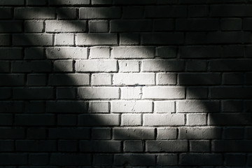 White brick wall with light spot