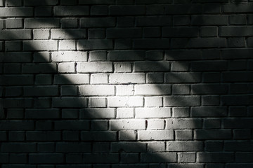 White brick wall with light spot