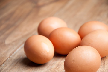 The image of eggs on a wooden table.