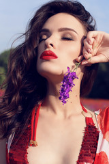 fashion outdoor photo of beautiful woman with dark hair in elegant bikini posing at summer blossom lavender field    