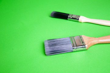 Brush and paint on a green background