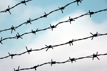 Barb wire against blue sky