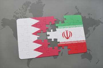 puzzle with the national flag of bahrain and iran on a world map background.