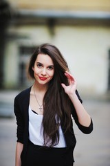 Fototapeta premium Portrait of young happy girl with long hair and bright makeup in