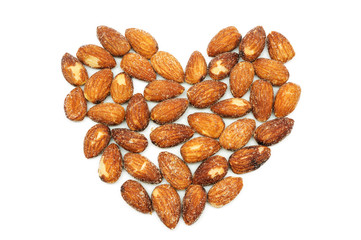 Almonds baking with salt on white background.