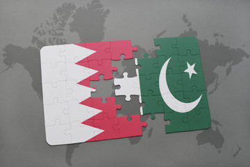 puzzle with the national flag of bahrain and pakistan on a world map background.