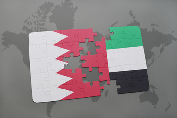 puzzle with the national flag of bahrain and united arab emirates on a world map background.