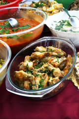 Dish with roasted chicken legs on the dinner table