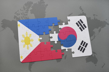 puzzle with the national flag of philippines and south korea on a world map background.