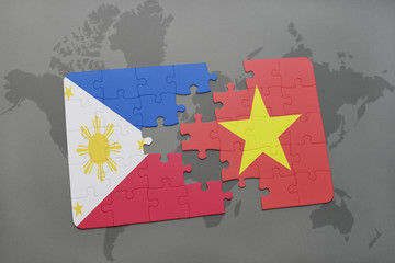 puzzle with the national flag of philippines and vietnam on a world map background.