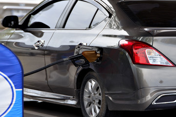 Fill the gas tank ,Gas pump nozzle in the fuel tank of a bronze car, refuel
