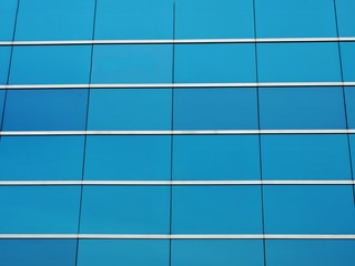 Blue glass wall of modern building background