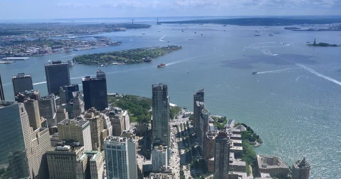 A unique high angle time lapse view of Lower Manhattan and Battery Park with Governors Island and the Verrazano-Narrows Bridge in the distance.  	
