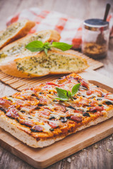 Homemade bacon pizza with garlic bread