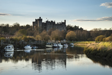 Landscape image of old medieval Castle viewed across River at su