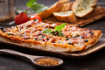 Homemade bacon pizza with garlic bread