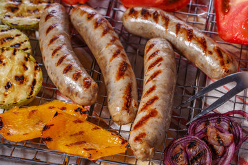 Cooked sausages on the grill grate.