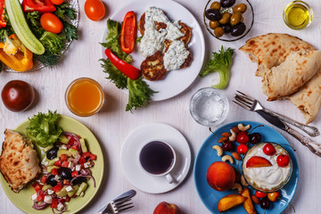 Greek appetizers  - fritters of zucchini, Greek salad, yogurt.