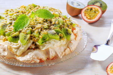 Meringue Pavlova  with whipped cream and fresh fruit.