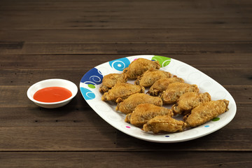 Fried chicken wings with hot sauce