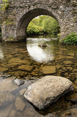 Landscape image of medieval bridge in river setting in English c