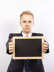 Junger Mann im Anzug mit Tafel f&uuml;r Text zur Werbung