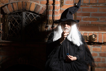 Old wizard with pendulum