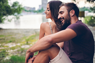 Couple sitting on the pier and laughing