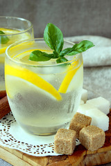 Glasses with cold lemonade and ice cubes..