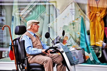 Fototapeta na wymiar Elderly Person on Electromobile