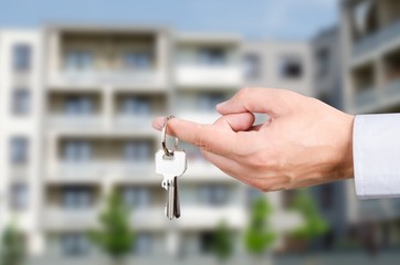 Man hand holding keys to new house