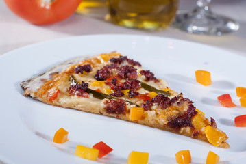 Italian gourmet pizza accompanied by red wine and spices