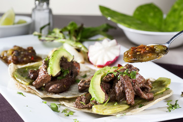 Mexican taco gourmet accompanied by avocado