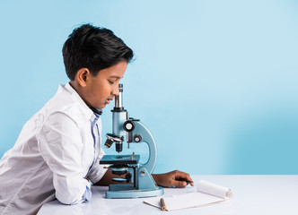 indian boy and chemistry experiment and microscope, asian boy with microscope and doing chemistry experiment, indian boy and science experiment