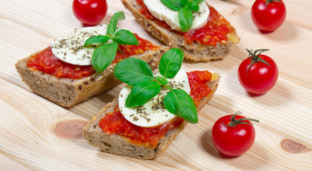 Italian bruschetta with cherry tomatoes, mozzarella & fresh basil.