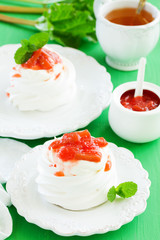 Dessert of meringue with rhubarb and mint sauce.